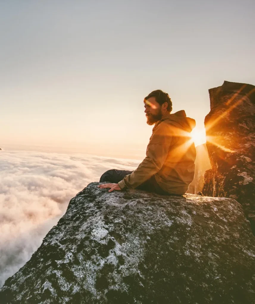 Man relaxing alone on the edge cliff mountain