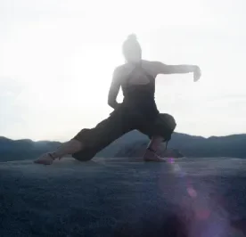 Woman practicing tai chi in the rocks