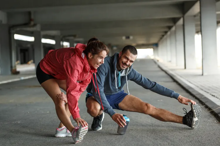 Young couple workout and doing exercise on city street